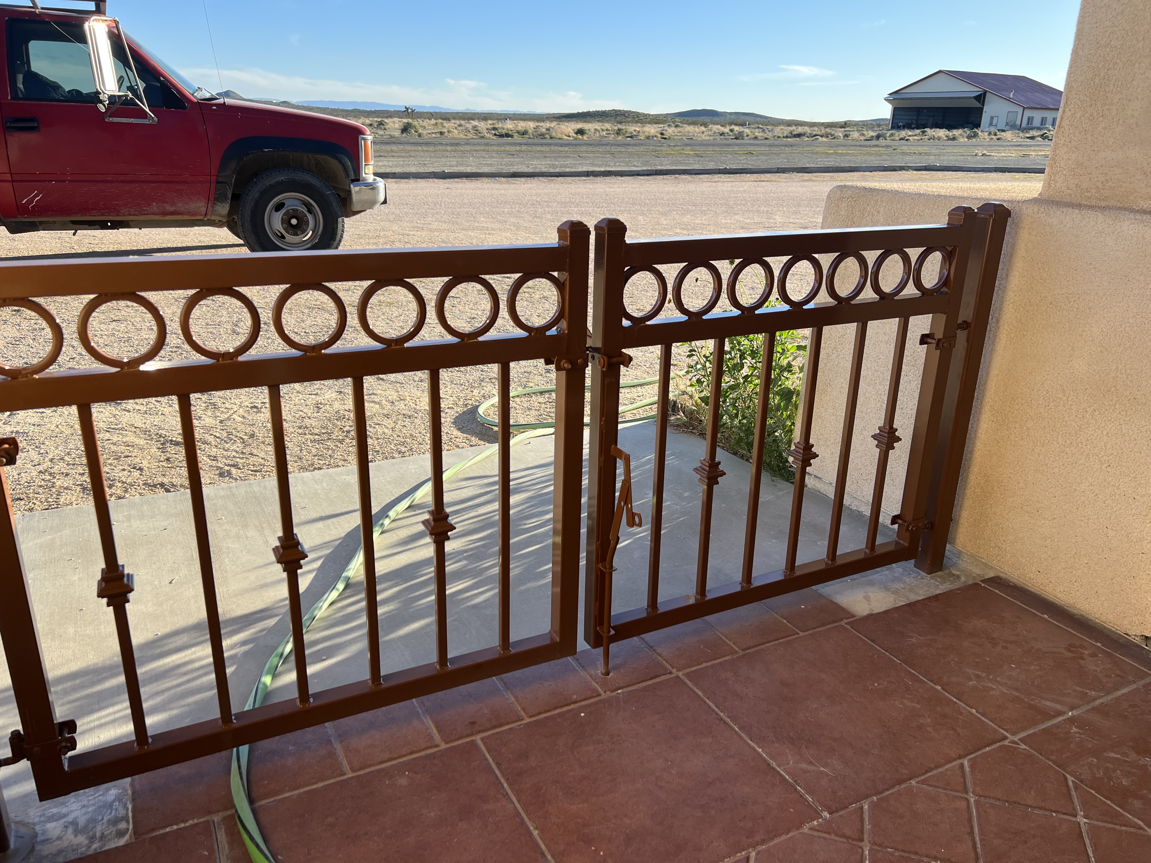 Ornamental iron fence with circle top — patio railing view