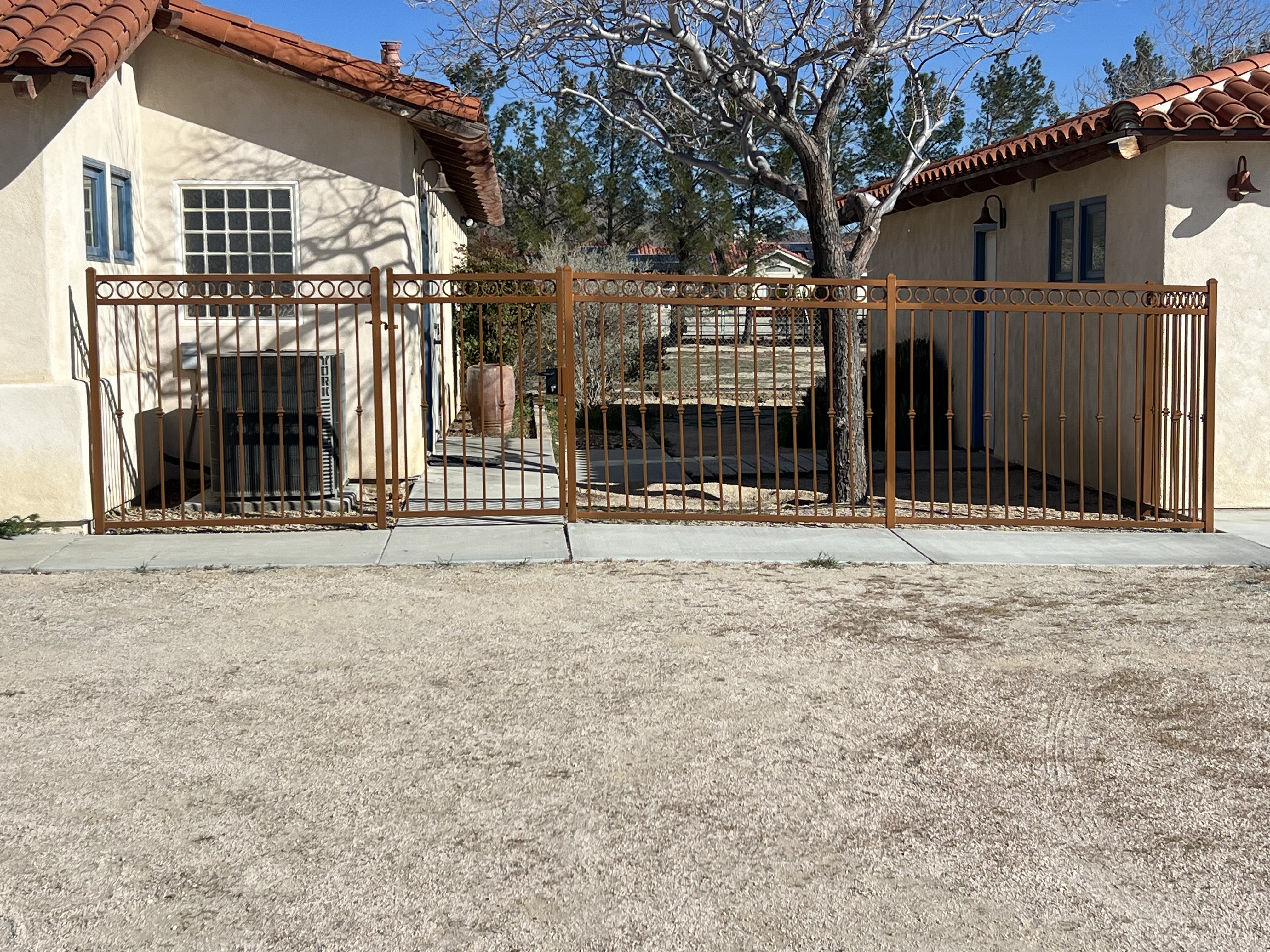 Ornamental wrought iron fence with circle top detail — full front view